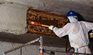 Asbestos Worker working on beams